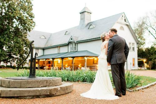wedding couple in front of bmp carriage house